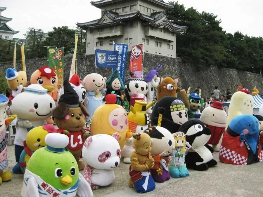 A group of Yuru chara mascots gathering in front of a temple